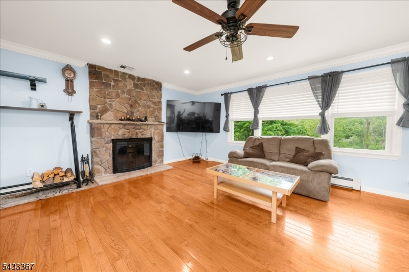 650 Woodglen Road Glen Gardner, NJ 08826 - Photo 5 of 28 a living room with furniture a fireplace and a flat screen tv