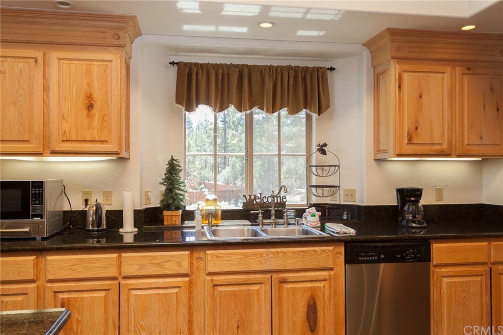 209 Rodeo Road Big Bear City, CA 92314 - Photo 12 of 39 a kitchen with granite countertop a sink a stove and cabinets