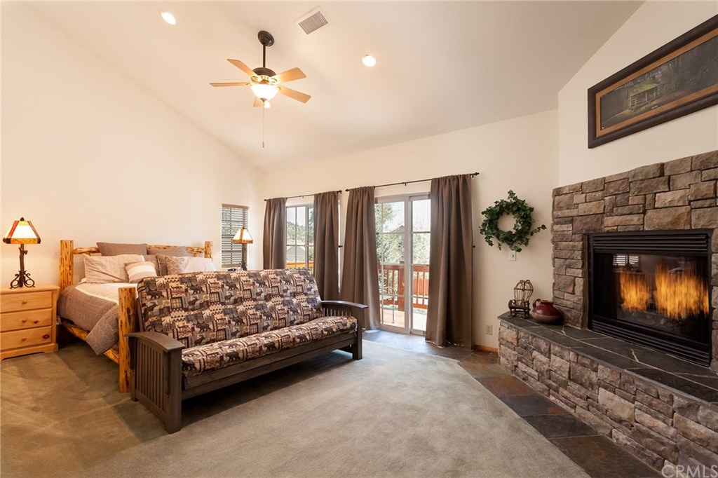 209 Rodeo Road Big Bear City, CA 92314 - Photo 17 of 39 a living room with furniture and a fireplace