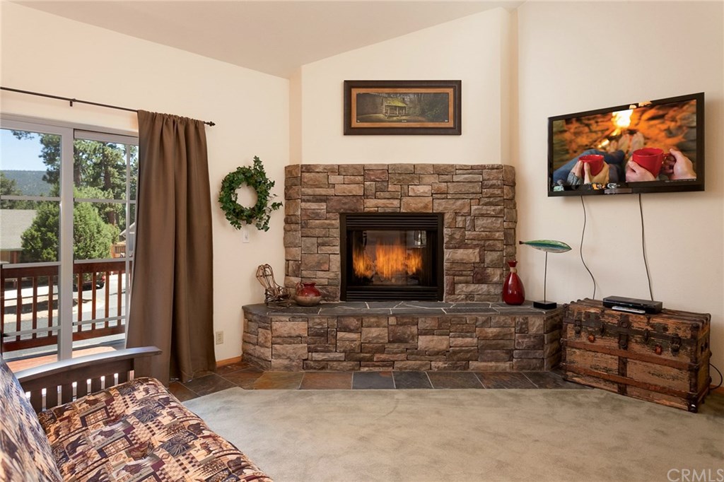 209 Rodeo Road Big Bear City, CA 92314 - Photo 18 of 39 a living room with furniture a flat screen tv and a fireplace