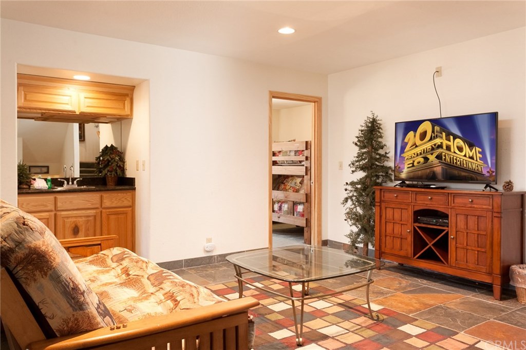209 Rodeo Road Big Bear City, CA 92314 - Photo 21 of 39 a living room with furniture and a flat screen tv