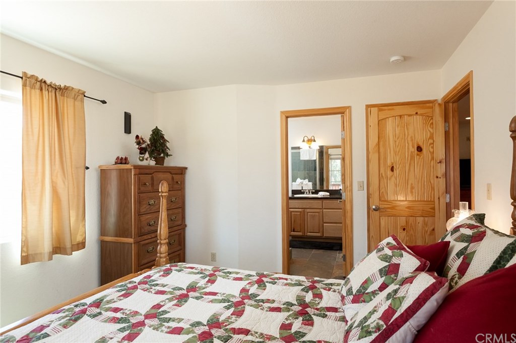 209 Rodeo Road Big Bear City, CA 92314 - Photo 25 of 39 a bedroom with a bed and wooden floor