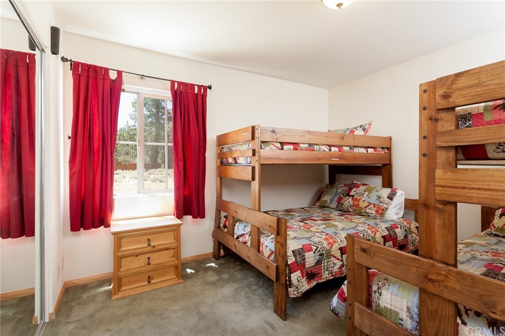 209 Rodeo Road Big Bear City, CA 92314 - Photo 28 of 39 a bedroom with furniture and a window