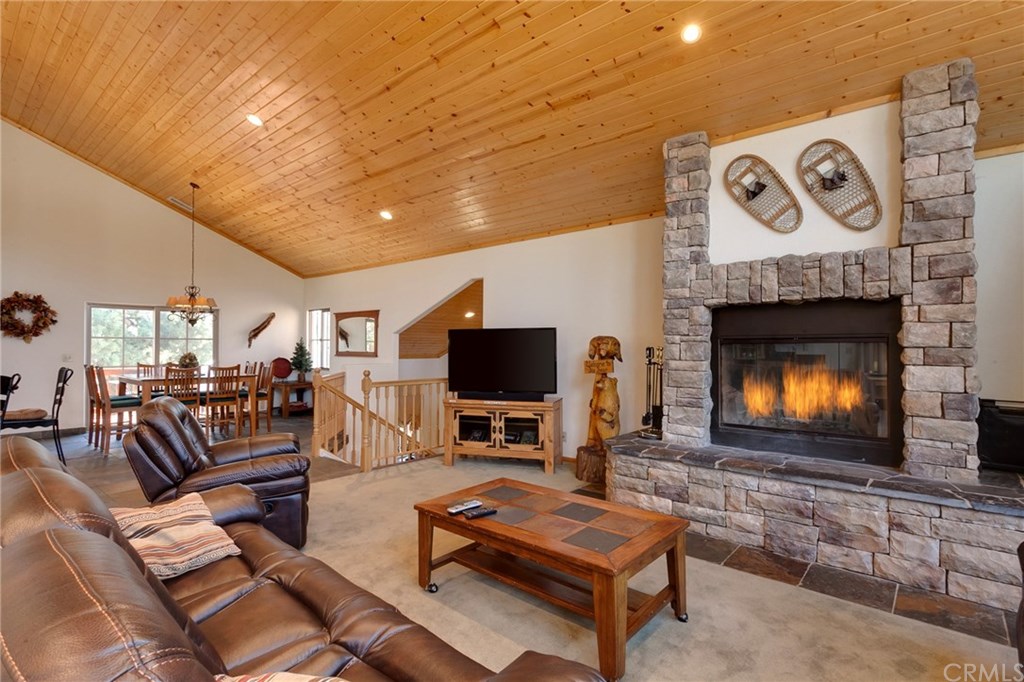 209 Rodeo Road Big Bear City, CA 92314 - Photo 4 of 39 a living room with furniture a flat screen tv and a fireplace