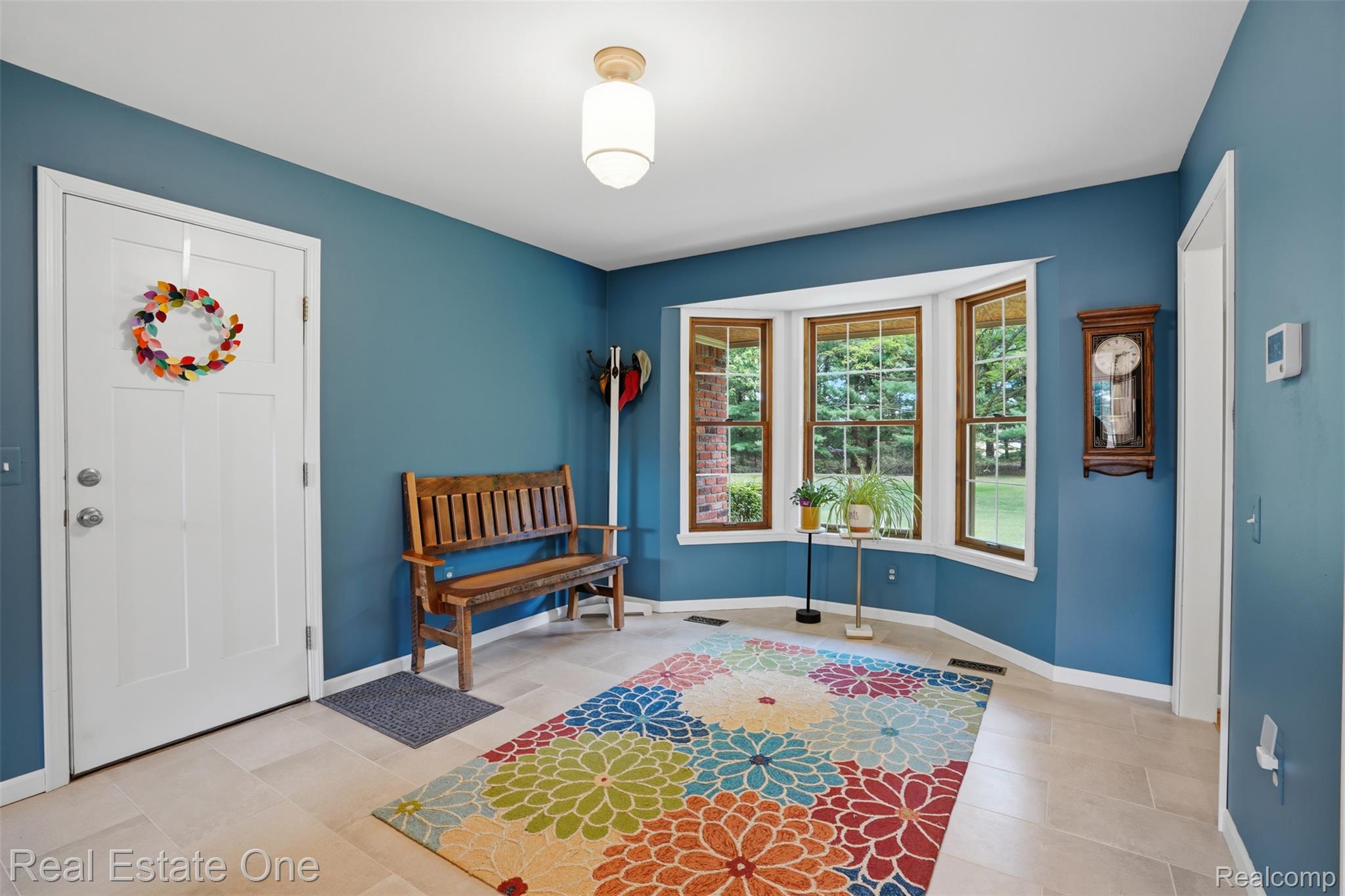 1765 Rowe Road Milford, MI 48380 - Photo 16 of 61 Entryway featuring light-toned tile flooring, a white paneled door, and a bay window with wood-framed sashes