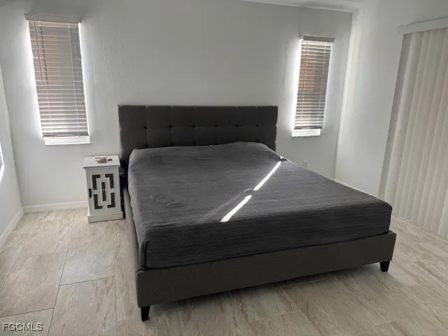 a bedroom with a bed and window