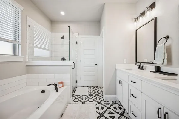 a bathroom with a tub sink and mirror