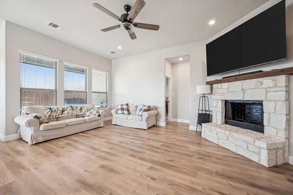 a living room with furniture fireplace and flat screen tv