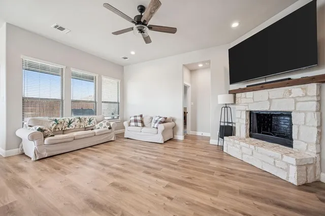 a living room with furniture fireplace and flat screen tv