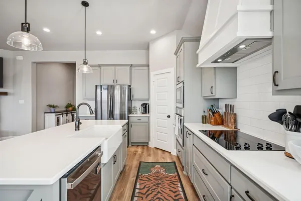 a kitchen with a sink appliances and cabinets