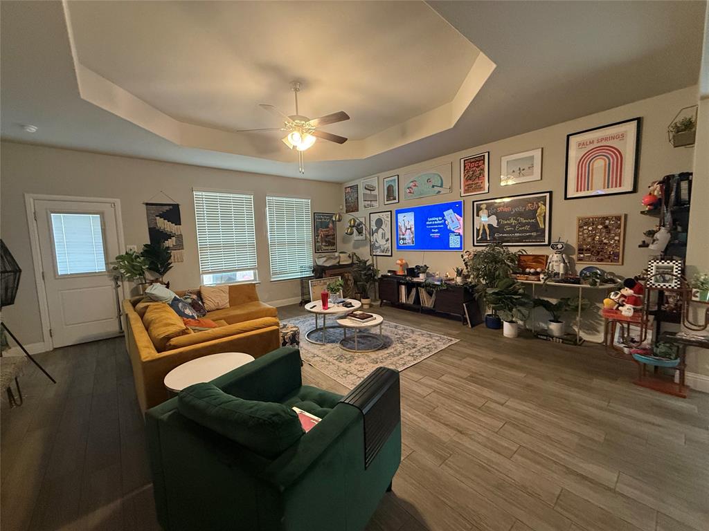 1121 Knightsbridge Road Argyle, TX 76226 - Photo 2 of 7 Living area featuring a ceiling fan, wood finished floors, and a raised ceiling