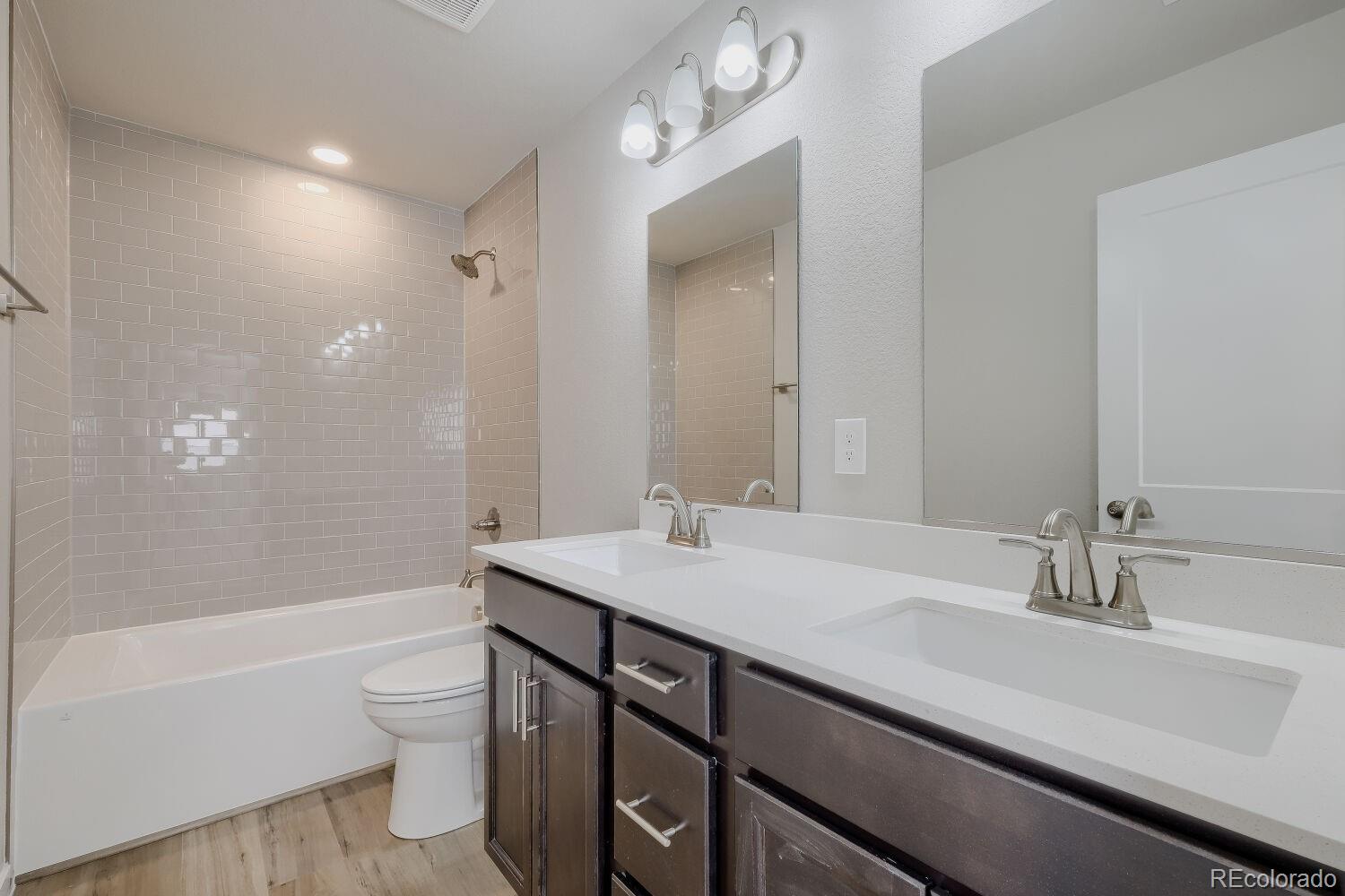 471 Atchison Way Calhan, CO 80808 - Photo 19 of 31 a bathroom with a sink a toilet a mirror and bathtub