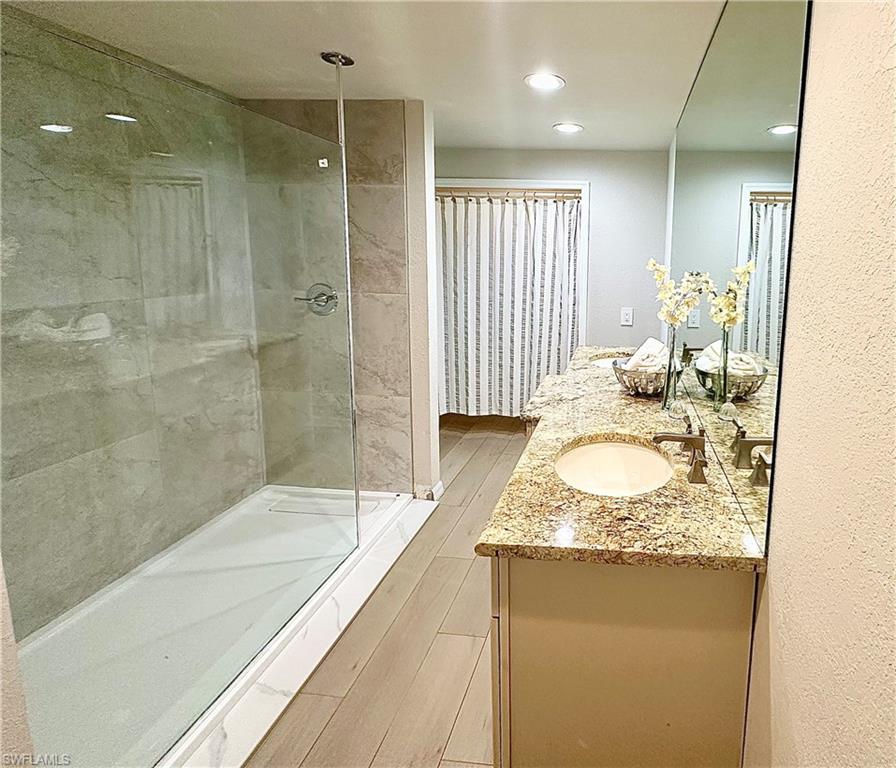 26261 Colony Road Bonita Springs, FL 34135 - Photo 11 of 31 Bathroom featuring walk in shower and vanity