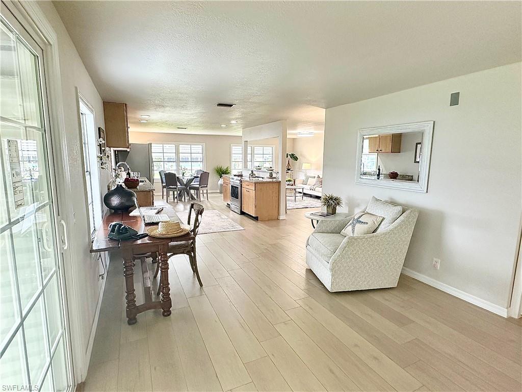 26261 Colony Road Bonita Springs, FL 34135 - Photo 4 of 31 Living room with light hardwood / wood-style floors