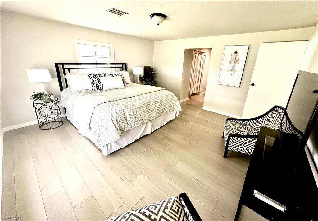26261 Colony Road Bonita Springs, FL 34135 - Photo 6 of 31 Bedroom with light hardwood / wood-style flooring