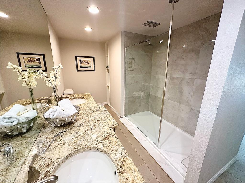 26261 Colony Road Bonita Springs, FL 34135 - Photo 9 of 31 Bathroom with walk in shower, toilet, and dual bowl vanity