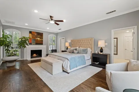 a spacious bedroom with a large bed and a fireplace