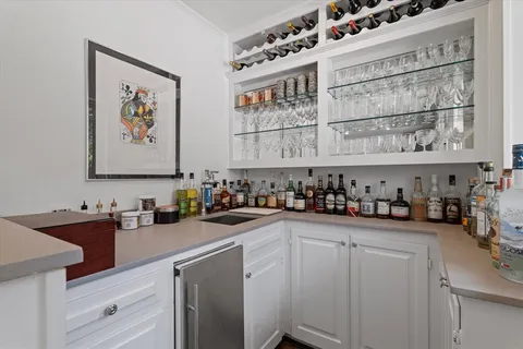 a kitchen with stainless steel appliances a sink a stove and cabinets