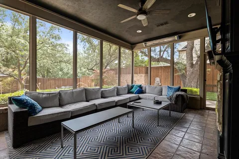 a living room with furniture and large windows