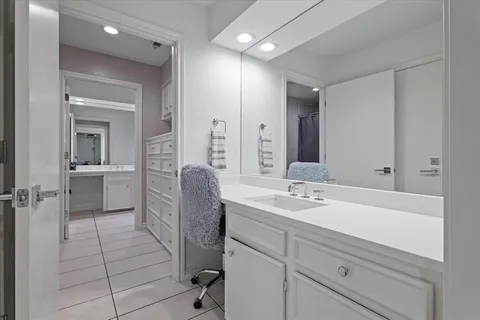 a bedroom with a bed cabinets and window