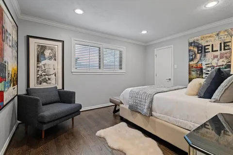 a bathroom with a painting on the wall and shower