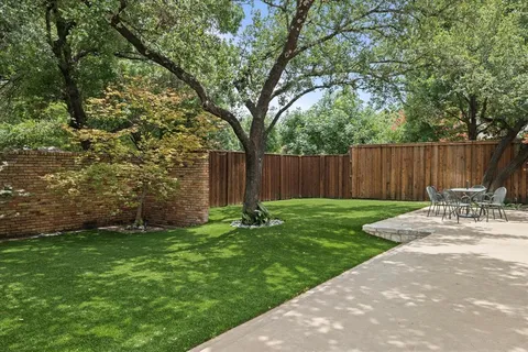 a view of a backyard patio with swimming pool