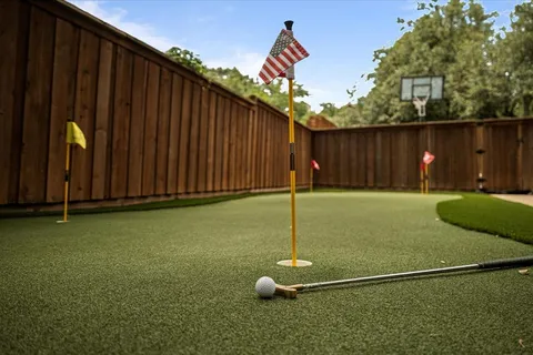 a view of backyard with wooden fence and a large tree