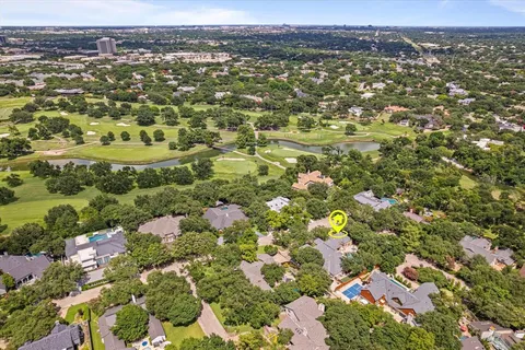 an aerial view of a house with a garden and trees