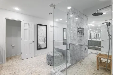 a bathroom with a glass shower door and a bathtub