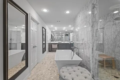 a bathroom with a bathtub and a shower