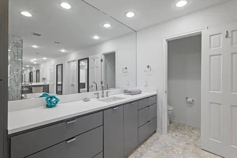 a view of bathroom with a sink and mirror