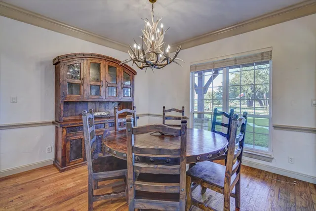 a spacious bedroom with a bed and a chandelier