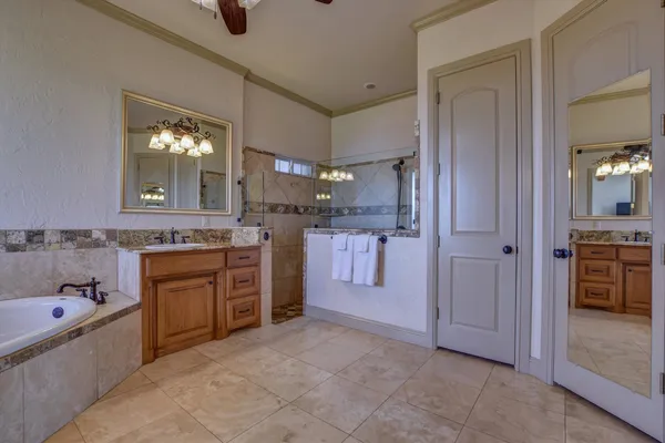 a large bathroom with a tub a sink and mirrors