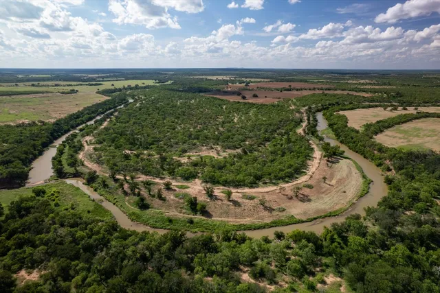 a bedroom with two beds and a chandelier