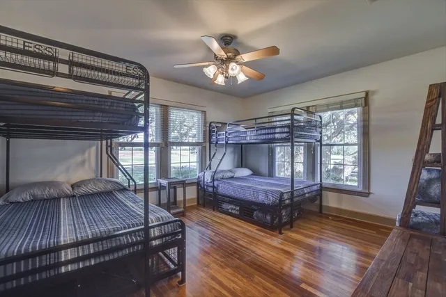 an aerial view of a house with a yard and lake view