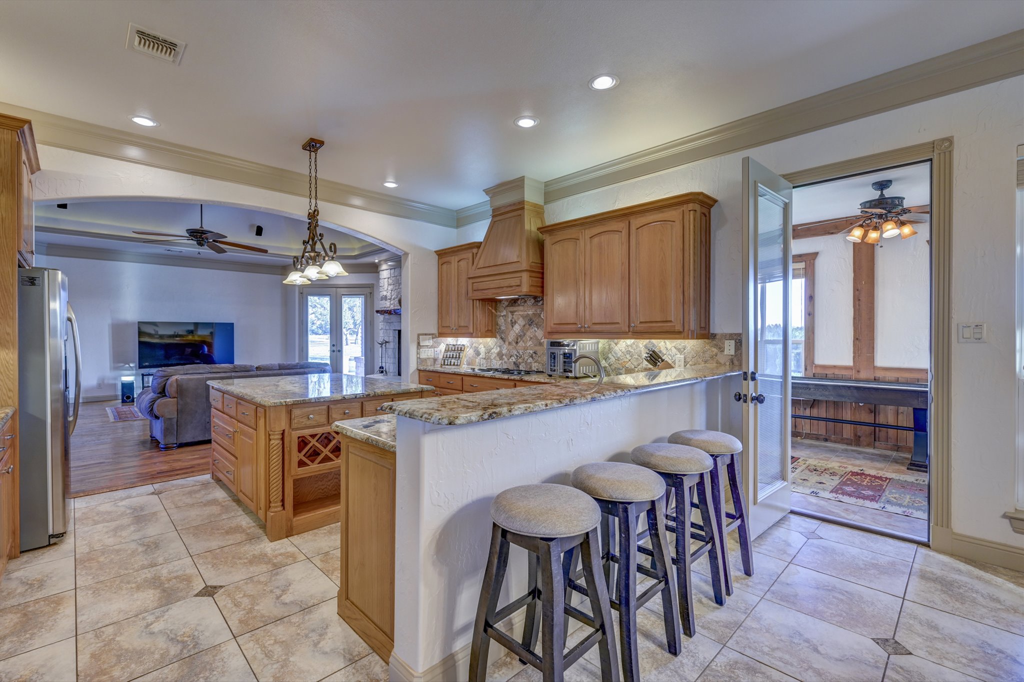 18601 County Road 214 Brookesmith, TX 76827 - Photo 10 of 39 a kitchen with stainless steel appliances granite countertop a table chairs sink and cabinets