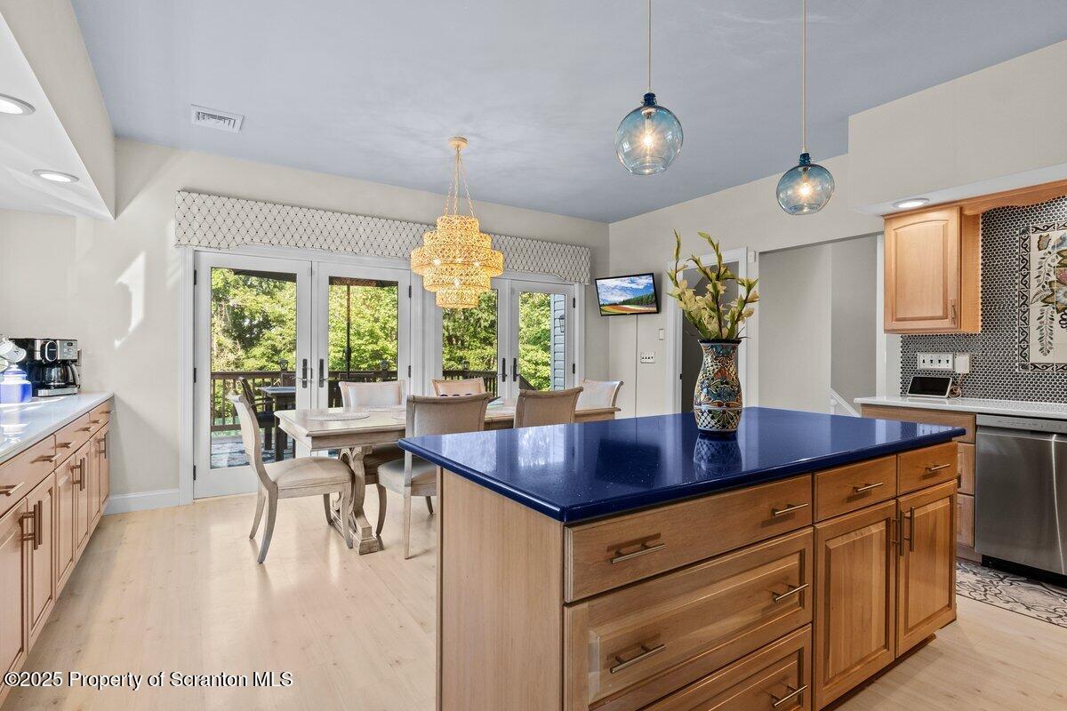 28 Ridgeview Drive Scranton, PA 18504 - Photo 26 of 55 a kitchen with stainless steel appliances granite countertop sink stove and white cabinets with wooden floor