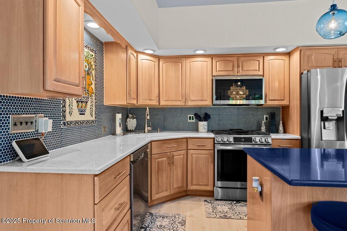 28 Ridgeview Drive Scranton, PA 18504 - Photo 27 of 55 a kitchen with stainless steel appliances granite countertop a sink stove microwave and refrigerator