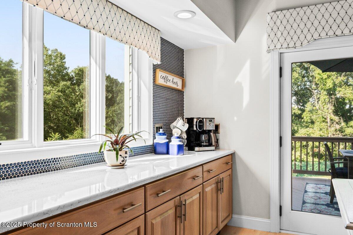 28 Ridgeview Drive Scranton, PA 18504 - Photo 28 of 55 a bathroom with a double vanity sink and a large mirror next to a window