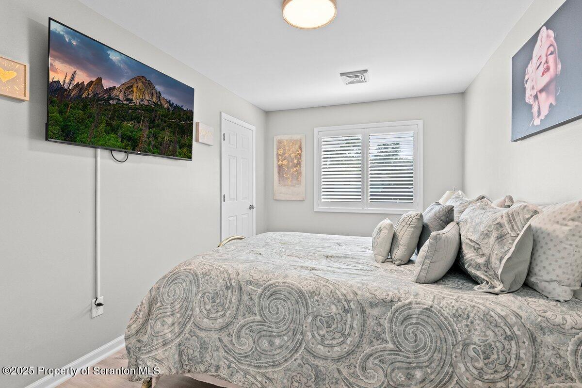 28 Ridgeview Drive Scranton, PA 18504 - Photo 37 of 55 a bedroom with a bed and a flat screen tv