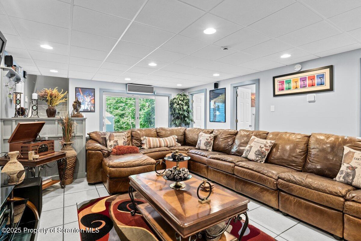 28 Ridgeview Drive Scranton, PA 18504 - Photo 47 of 55 a living room with furniture a large window and a flat screen tv