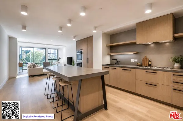 a kitchen with sink cabinets and living room view