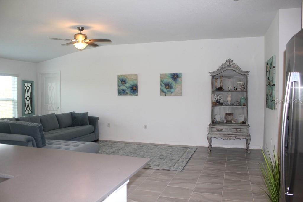 5010 Four Strand Court St. Cloud, FL 34772 - Photo 12 of 34 a living room with furniture and a chandelier