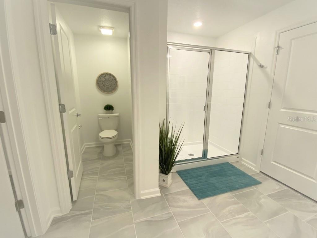 5010 Four Strand Court St. Cloud, FL 34772 - Photo 15 of 34 a view of a bathroom with a glass door shower