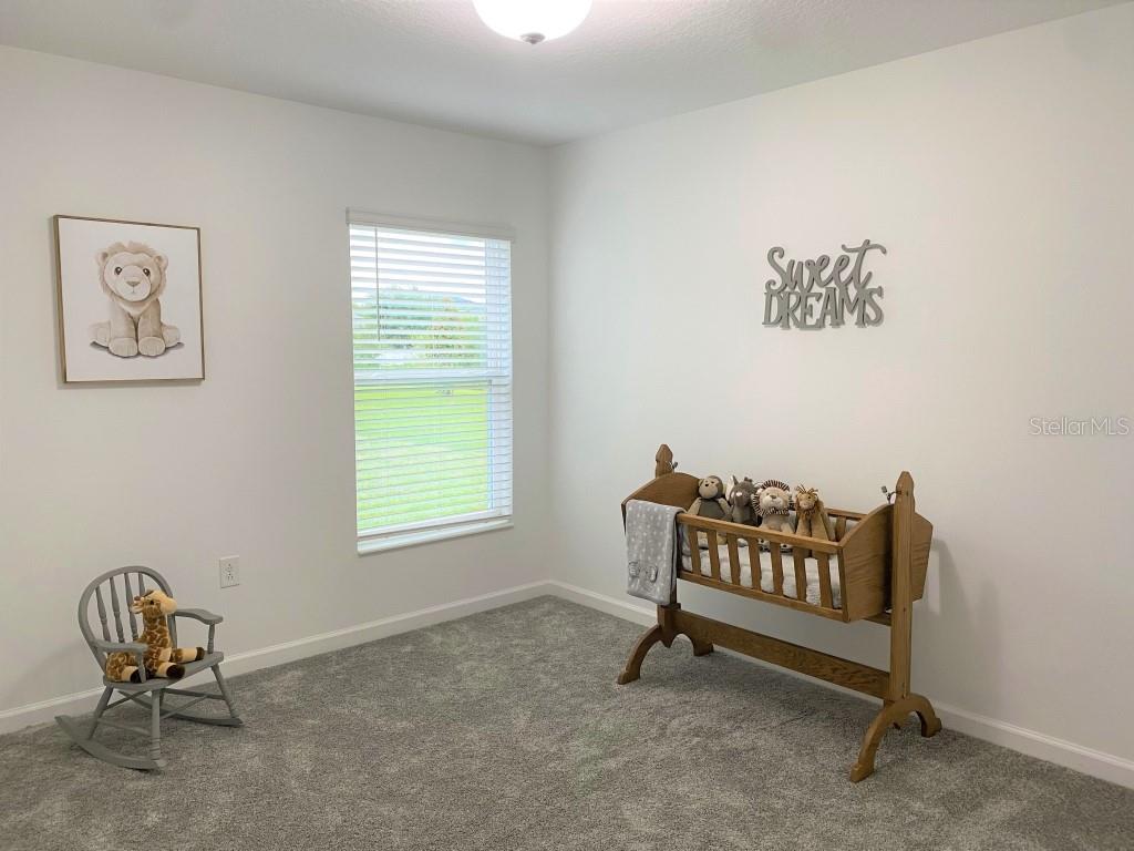 5010 Four Strand Court St. Cloud, FL 34772 - Photo 20 of 34 a living room with a chair and a window