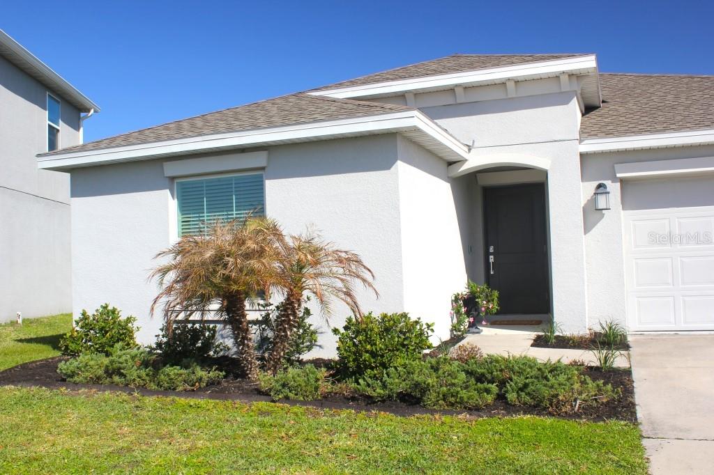 5010 Four Strand Court St. Cloud, FL 34772 - Photo 25 of 34 a front view of a house with garden