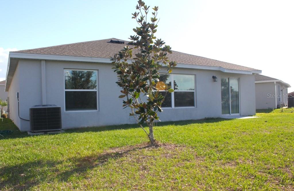 5010 Four Strand Court St. Cloud, FL 34772 - Photo 27 of 34 a house that has a tree in front of it