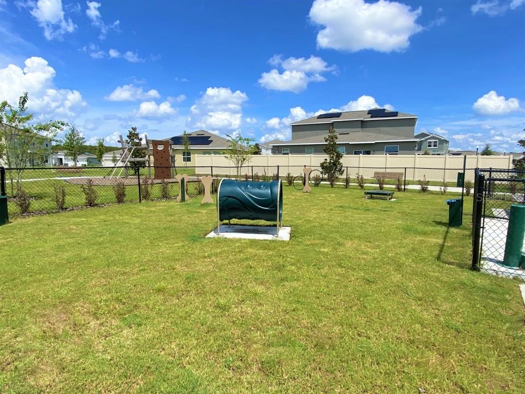 5010 Four Strand Court St. Cloud, FL 34772 - Photo 31 of 34 a view of a swimming pool with a yard