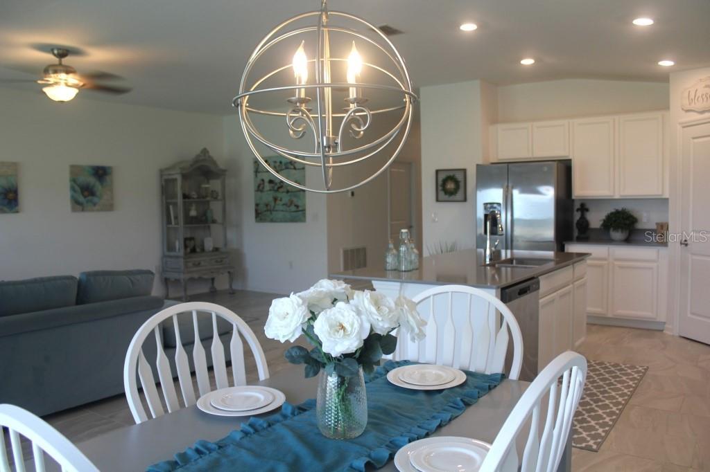 5010 Four Strand Court St. Cloud, FL 34772 - Photo 4 of 34 a kitchen with furniture and a mirror