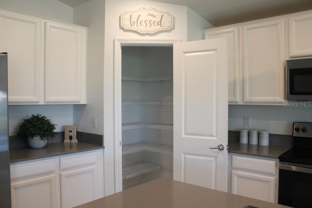 5010 Four Strand Court St. Cloud, FL 34772 - Photo 10 of 34 a kitchen with a sink and cabinets